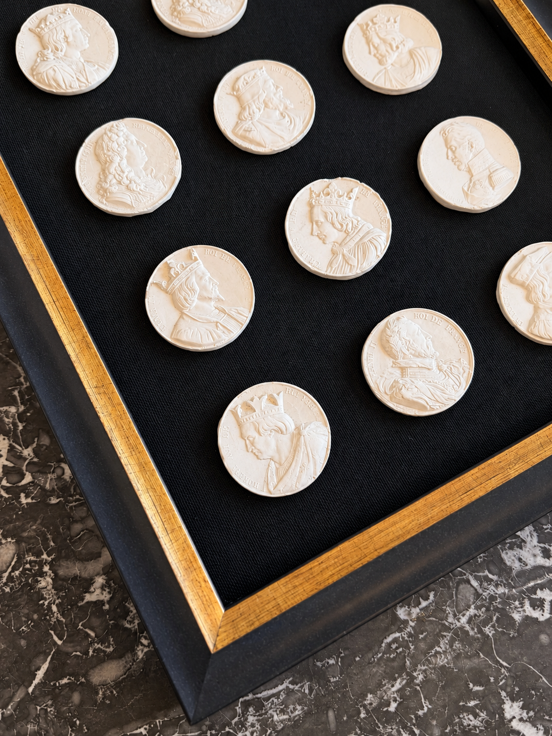 19th-century French royal portrait intaglios displayed on a surface, featuring detailed carved images from Housebound Interiors collection.