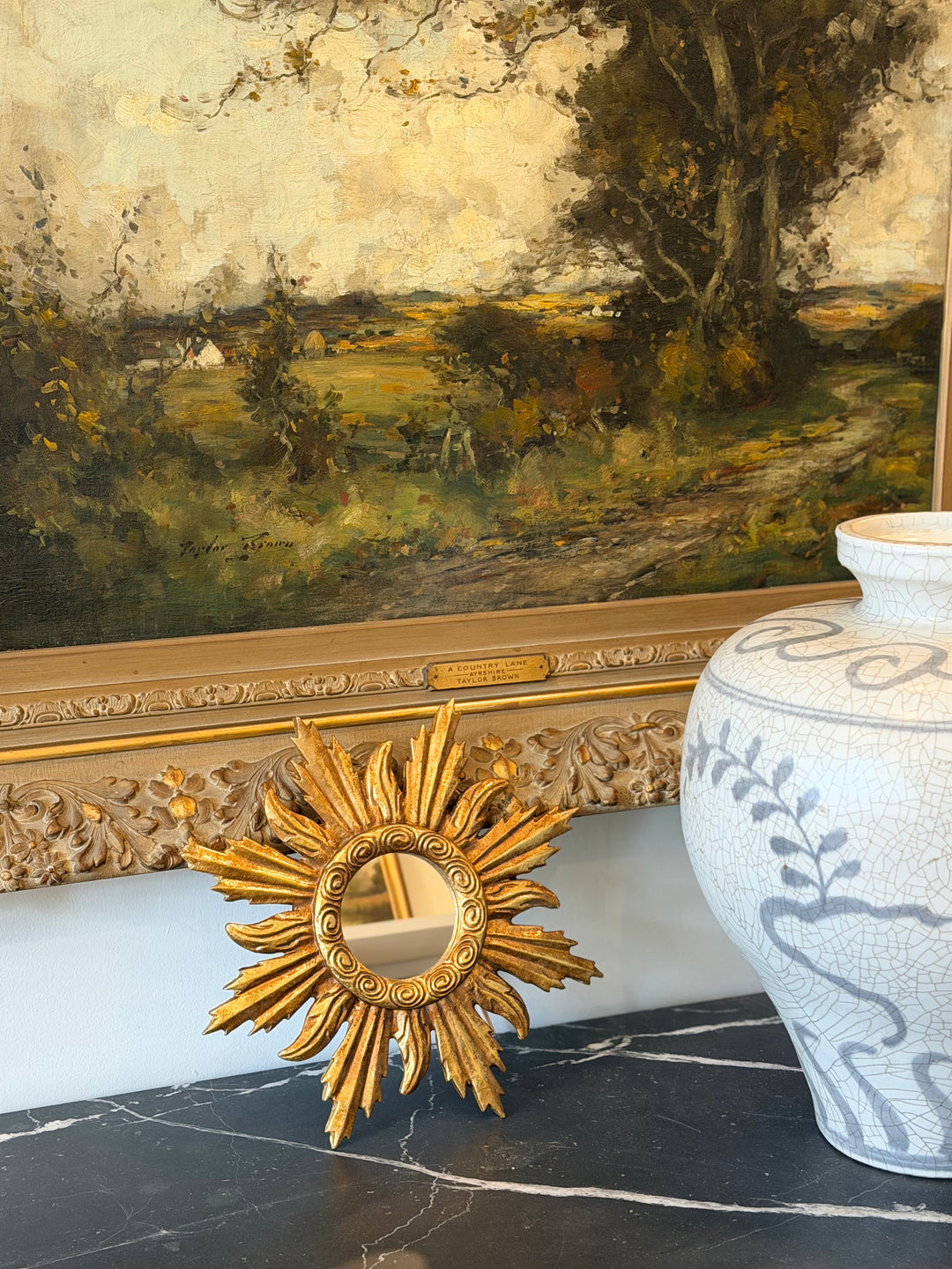 Gilt Sunburst Louis XIV Style Mirror with ornate gold frame and intricate detailing, vintage-inspired wall decor.