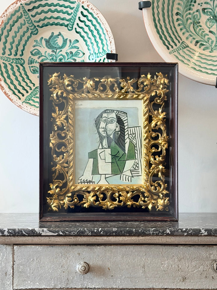 Seated female portrait artwork by Pablo Picasso from 1953, featuring bold lines and abstract style, displayed in a modern interior setting.