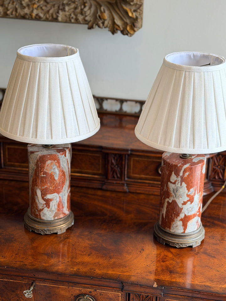 Italian marble column lamps in rouge and ivory with custom pleated shades, by Housebound Interiors.