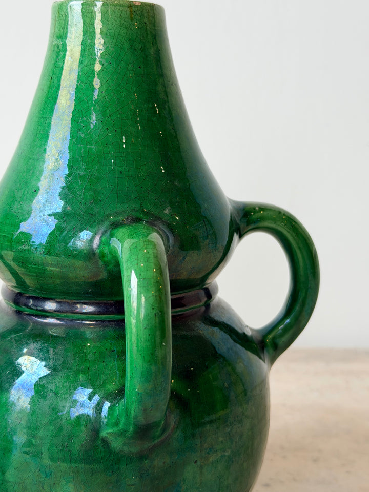 Pair of mid-20th century Belgian green glazed ceramic vessels with rounded shapes and decorative detailing, by Housebound Interiors.