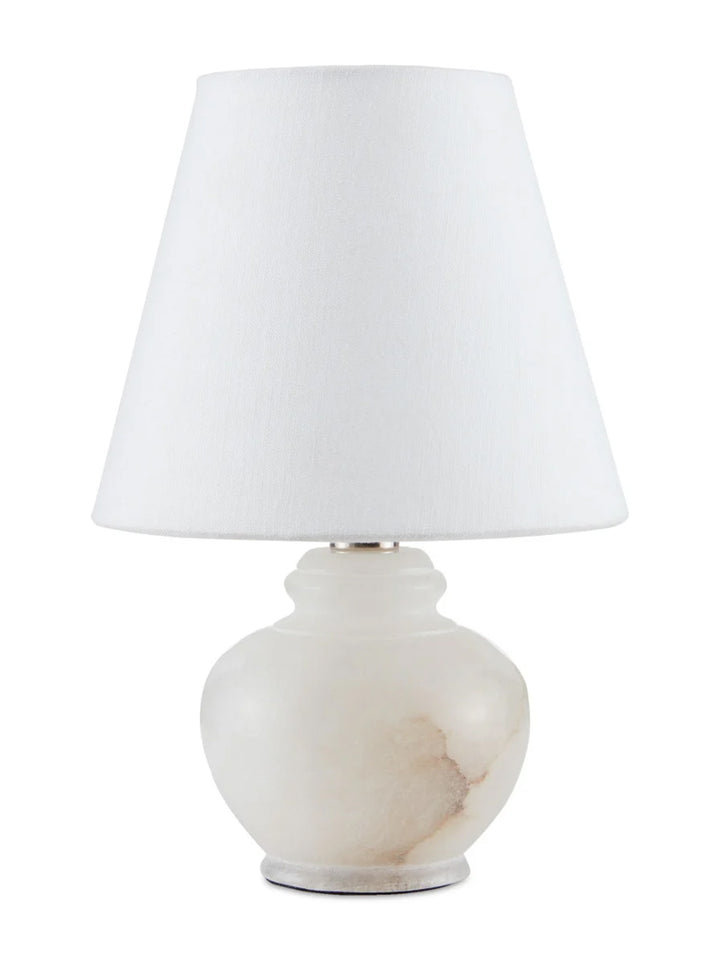 Petite alabaster table lamp by Housebound Interiors with a smooth, rounded alabaster base and a simple fabric shade.