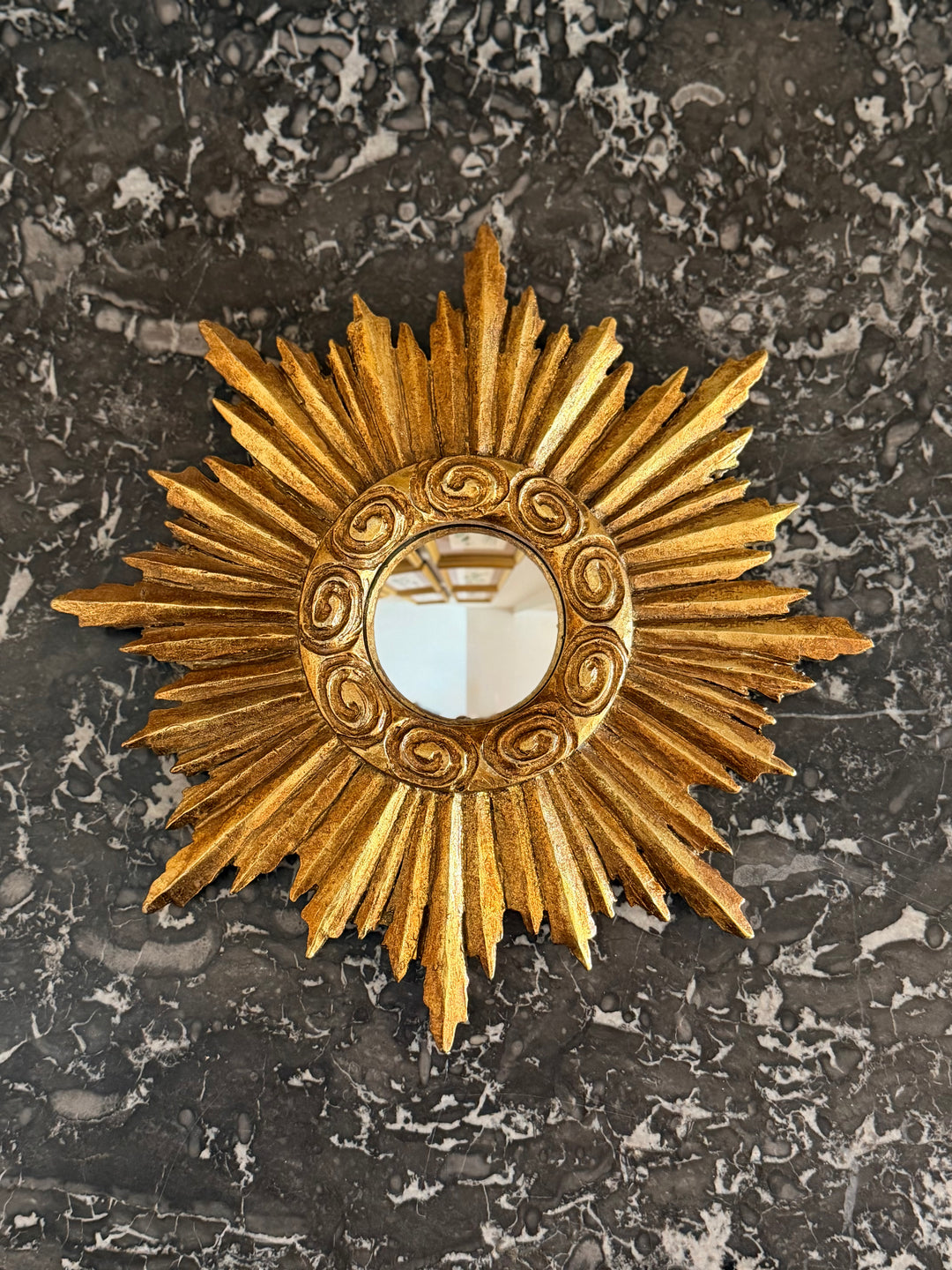 Gilt Sunburst Convex Mirror by Housebound Interiors with a gold sunburst frame and convex glass, decorative wall mirror.