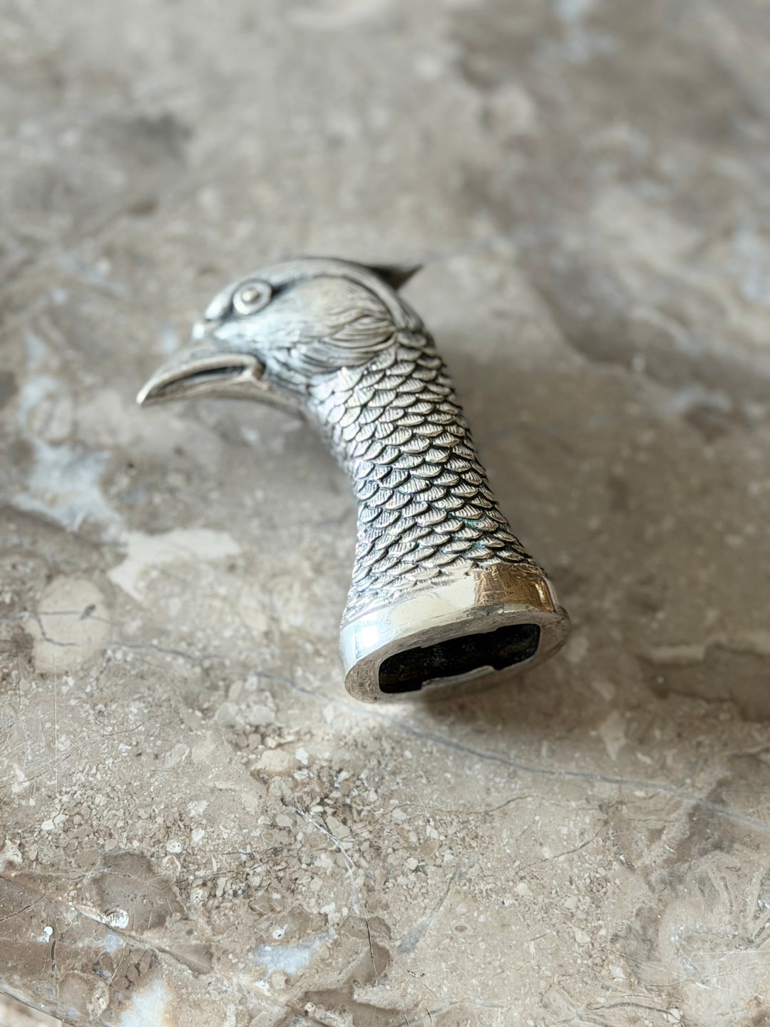 Silver bird-shaped bottle opener with 1950s design, sculptural style, and vintage aesthetic, from Housebound Interiors.