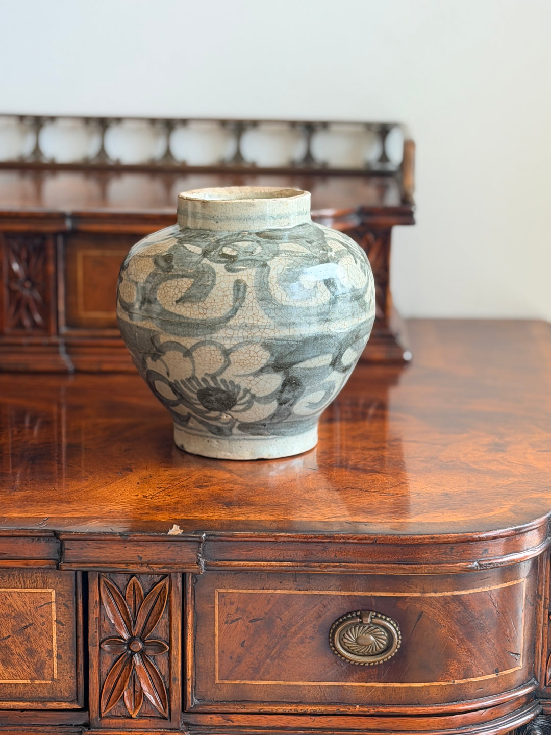 Hand-painted floral ceramic vase from the early 20th century by Housebound Interiors, featuring intricate botanical designs.