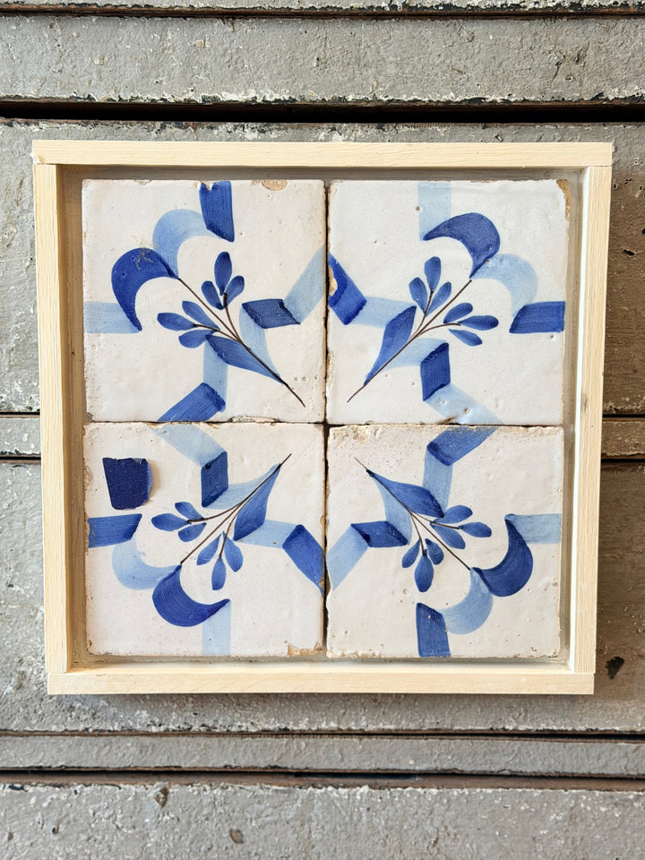 Antique blue and white ceramic tile panel by Housebound Interiors, showcasing intricate traditional design and glossy finish.