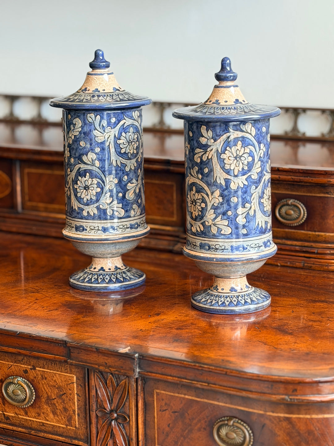 Pair of vintage Italian faience lidded urns with intricate blue and white patterns, crafted by Housebound Interiors.