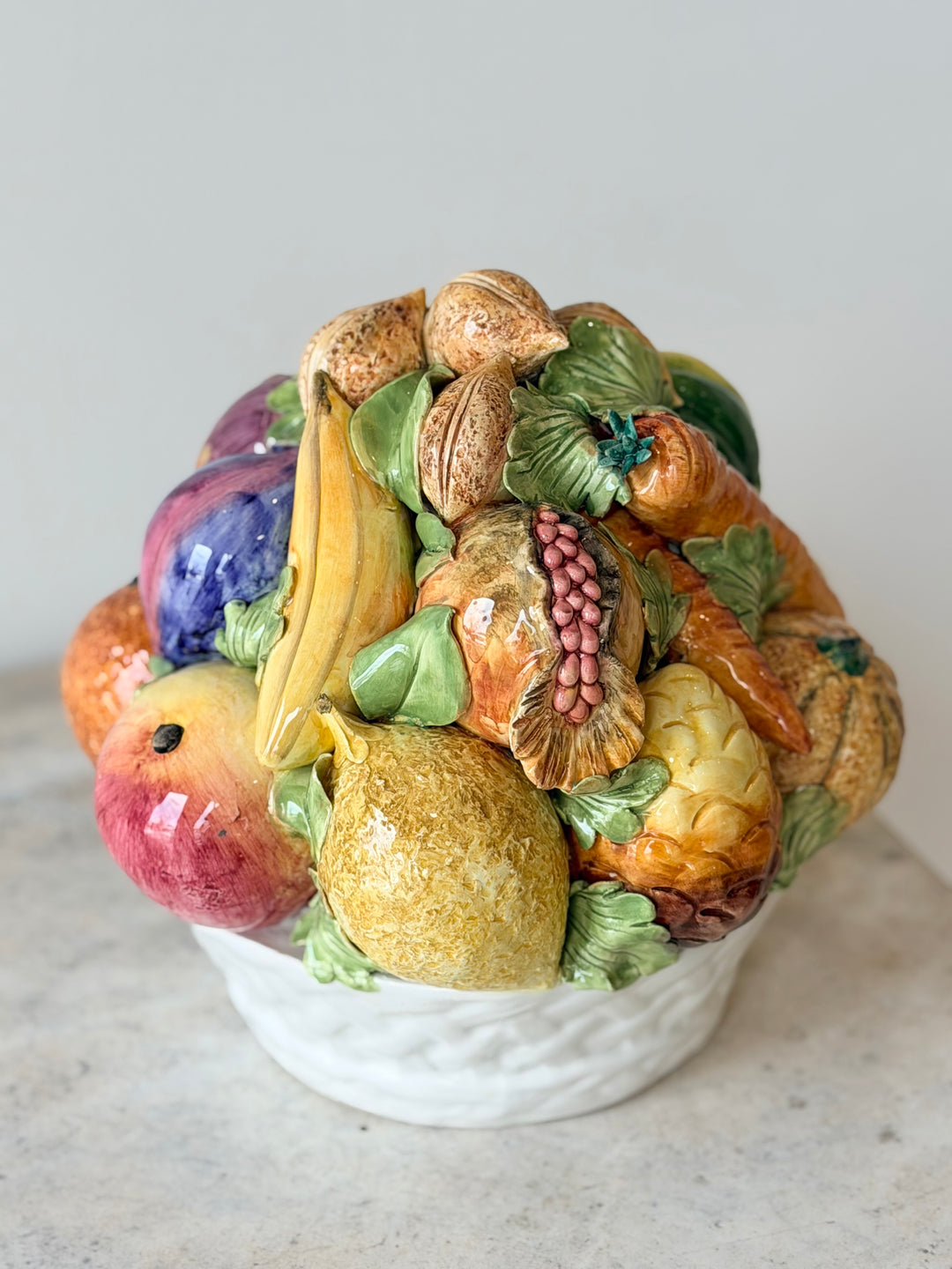 Mid-20th century Italian Majolica fruit topiary centerpiece featuring colorful ceramic fruit and decorative foliage.