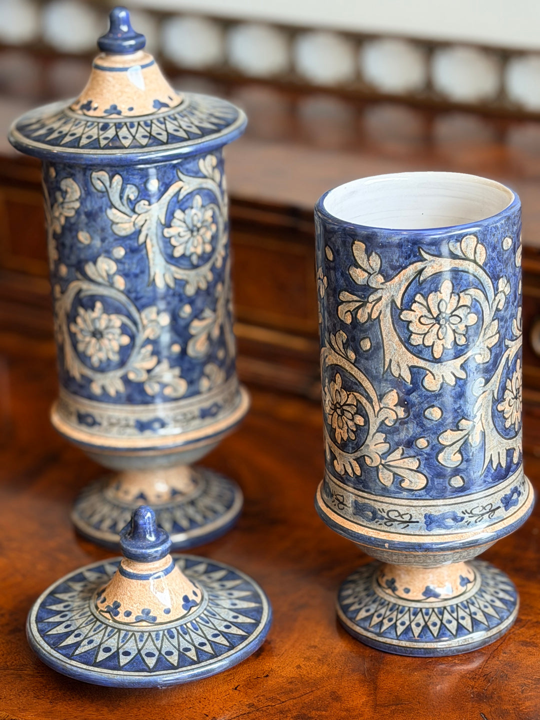 Pair of vintage Italian faience lidded urns with intricate hand-painted designs, perfect for classic home décor.