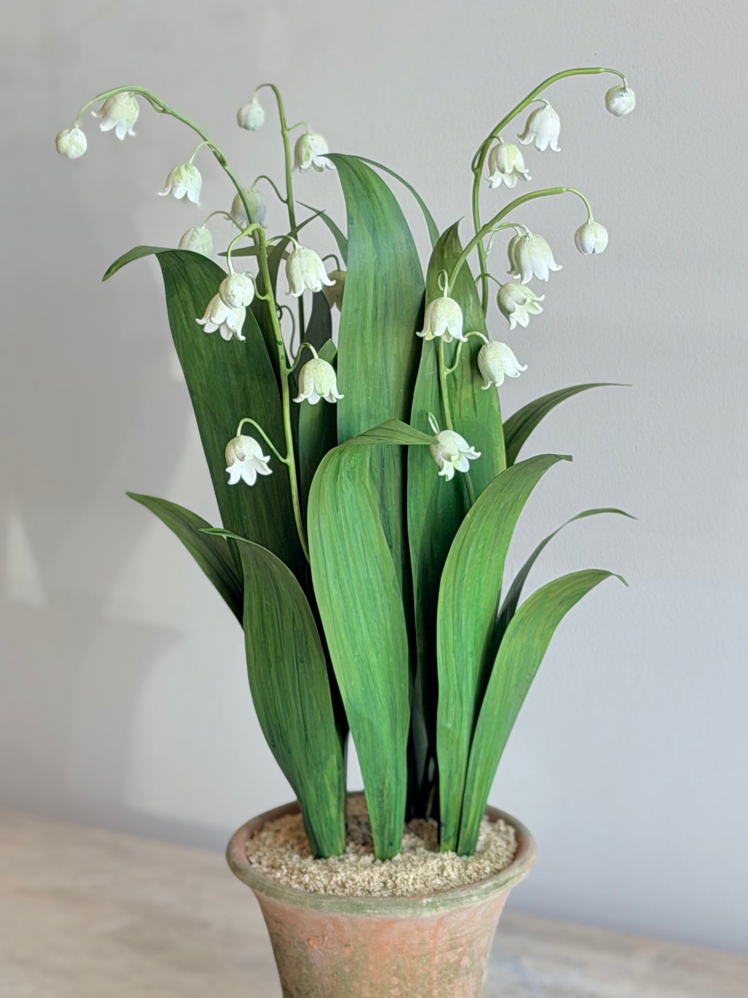 Lily of the Valley tole sculpture in an aged terracotta pot by Housebound Interiors, featuring delicate white flowers and green foliage.