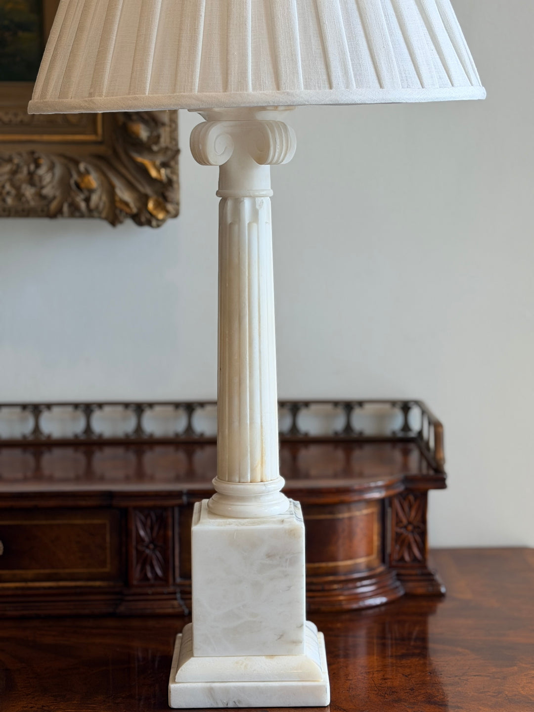Large Italian marble column table lamp with custom pleated linen shade from Housebound Interiors, showcasing elegant marble and classic design.