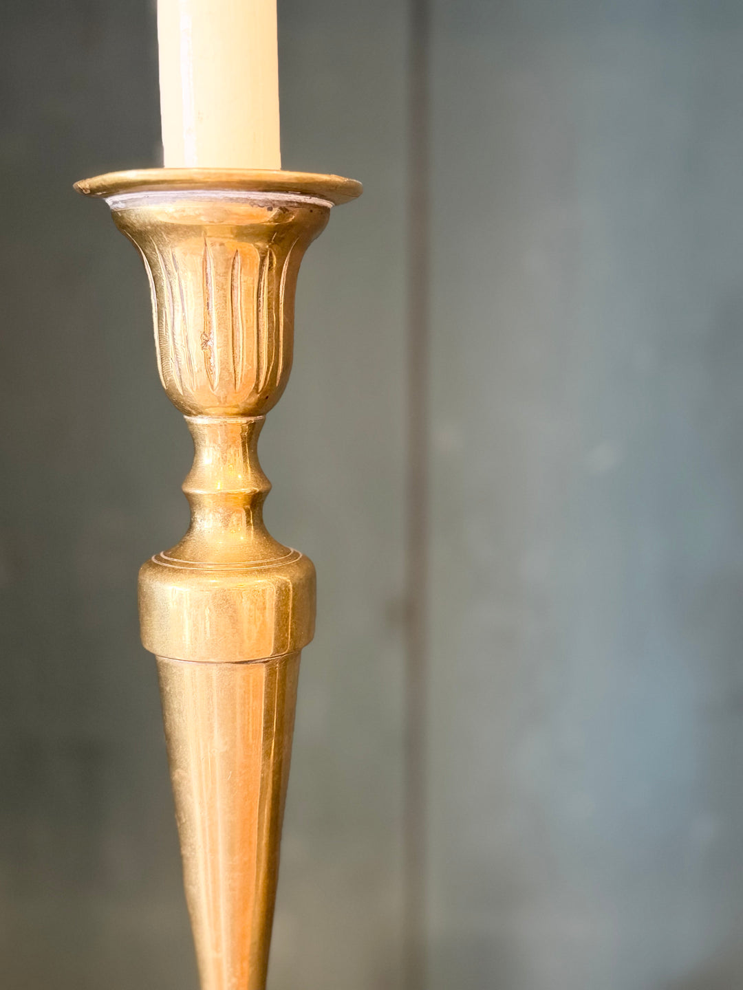 Pair of English brass candlestick table lamps with intricate detailing and warm finish, designed by Housebound Interiors.