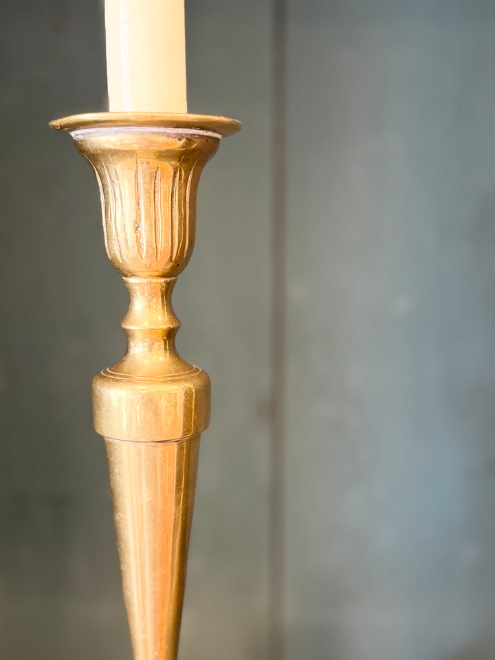 Pair of English brass candlestick table lamps with intricate detailing and warm finish, designed by Housebound Interiors.