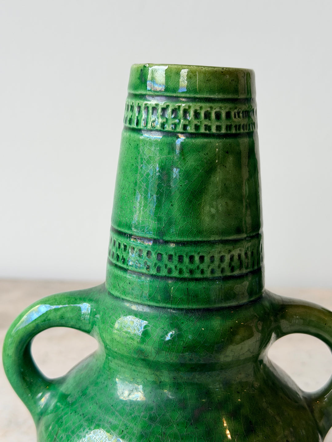 Pair of mid-20th century Belgian green glazed ceramic vessels with rounded shapes and textured surfaces, from Housebound Interiors.