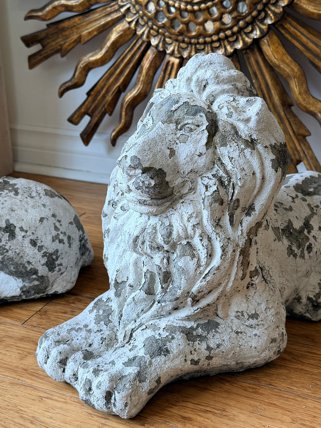 Pair of 20th-century French cast stone garden lions in a recumbent pose, detailed stone sculpture for outdoor decor.