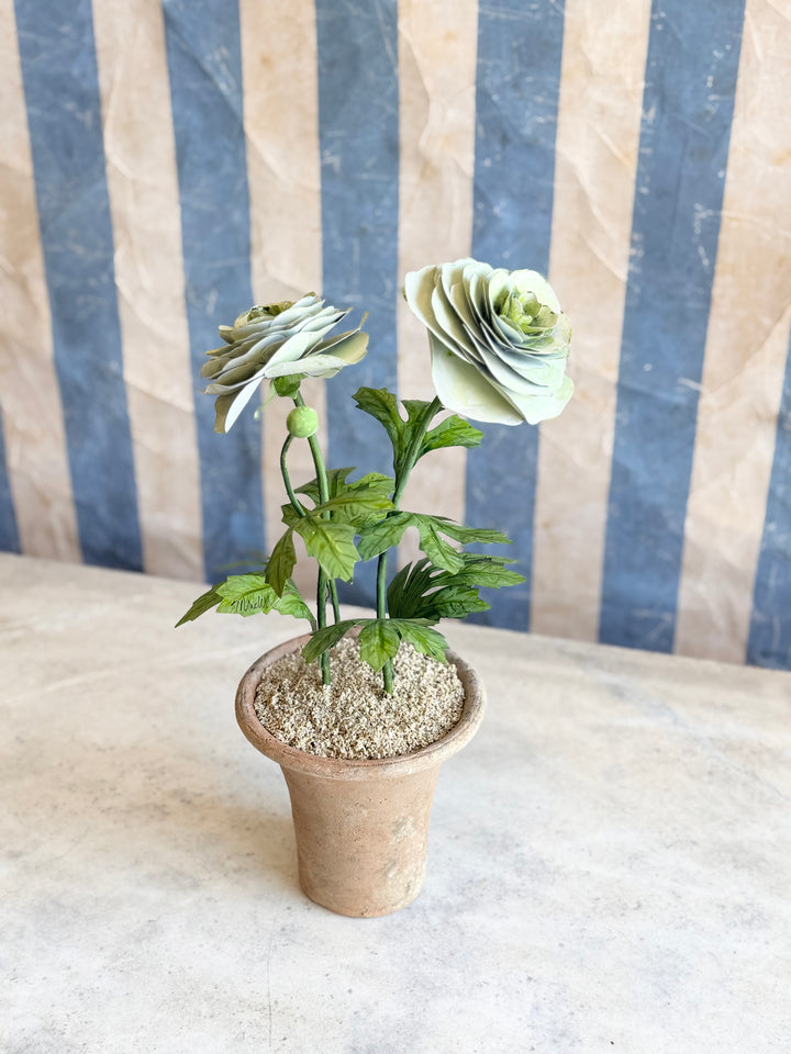 Pale green ranunculus tole sculpture in aged terracotta pot by Housebound Interiors, decorative floral art for home decor.