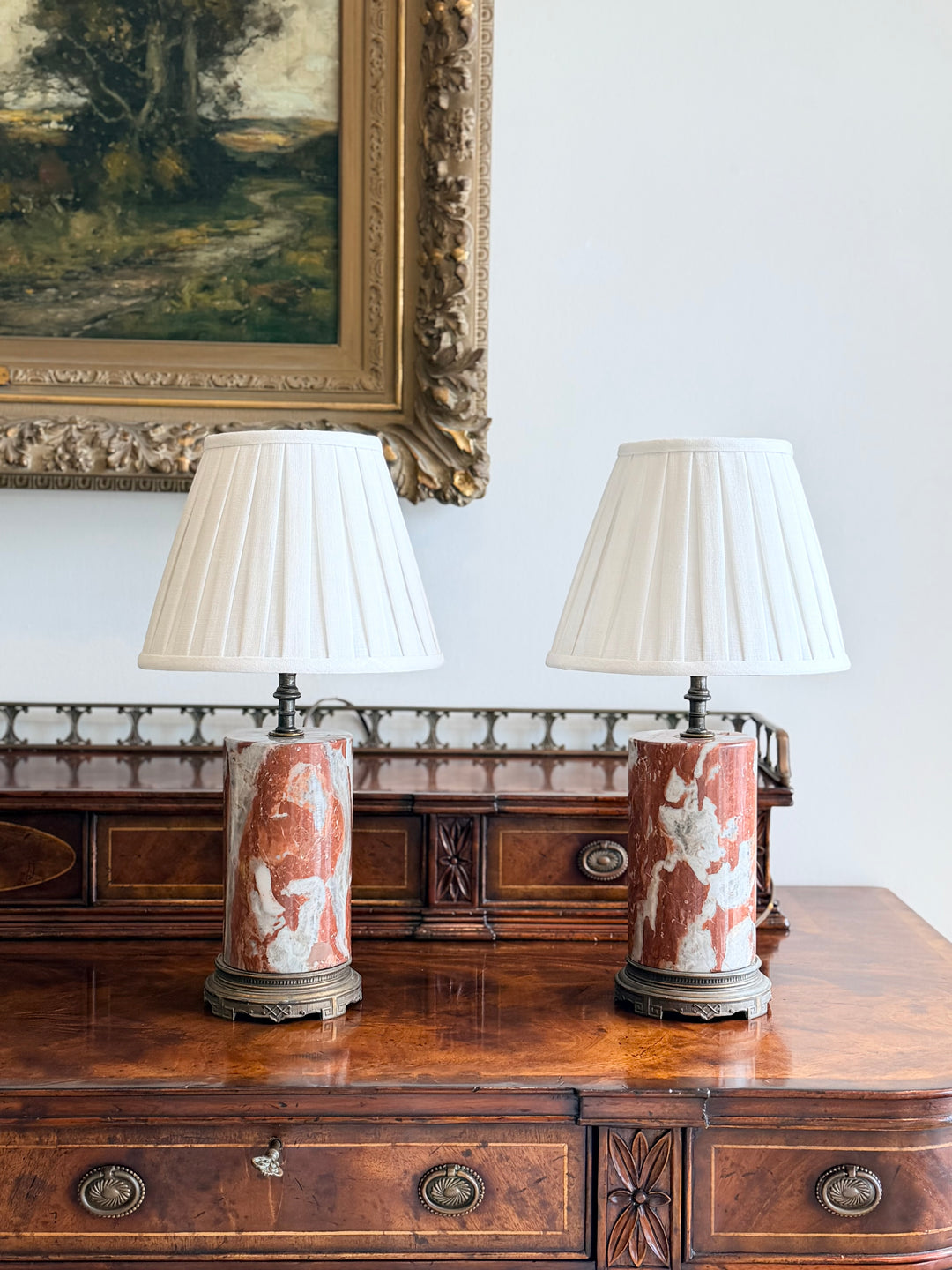 Italian rouge and ivory marble column lamps with custom pleated shades, showcasing elegant design and detailed craftsmanship.