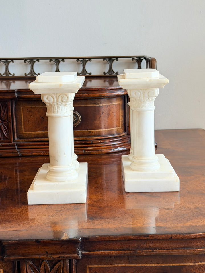 Pair of 1940s Italian carved marble Corinthian column bookends with intricate detailing, ideal for classic interior decor.