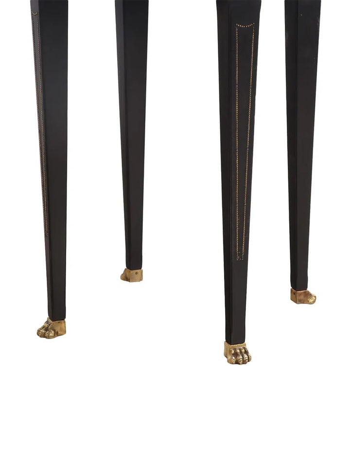 Pair of Italian ebonized side tables with gilt glass tops and brass claw feet, circa 1950.