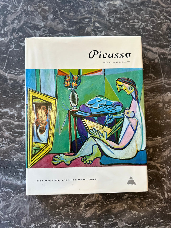 Book cover of "Picasso" by Hans L. C. Jaffé from the Library of Great Painters series, Abrams 1960s edition, displayed on a shelf.